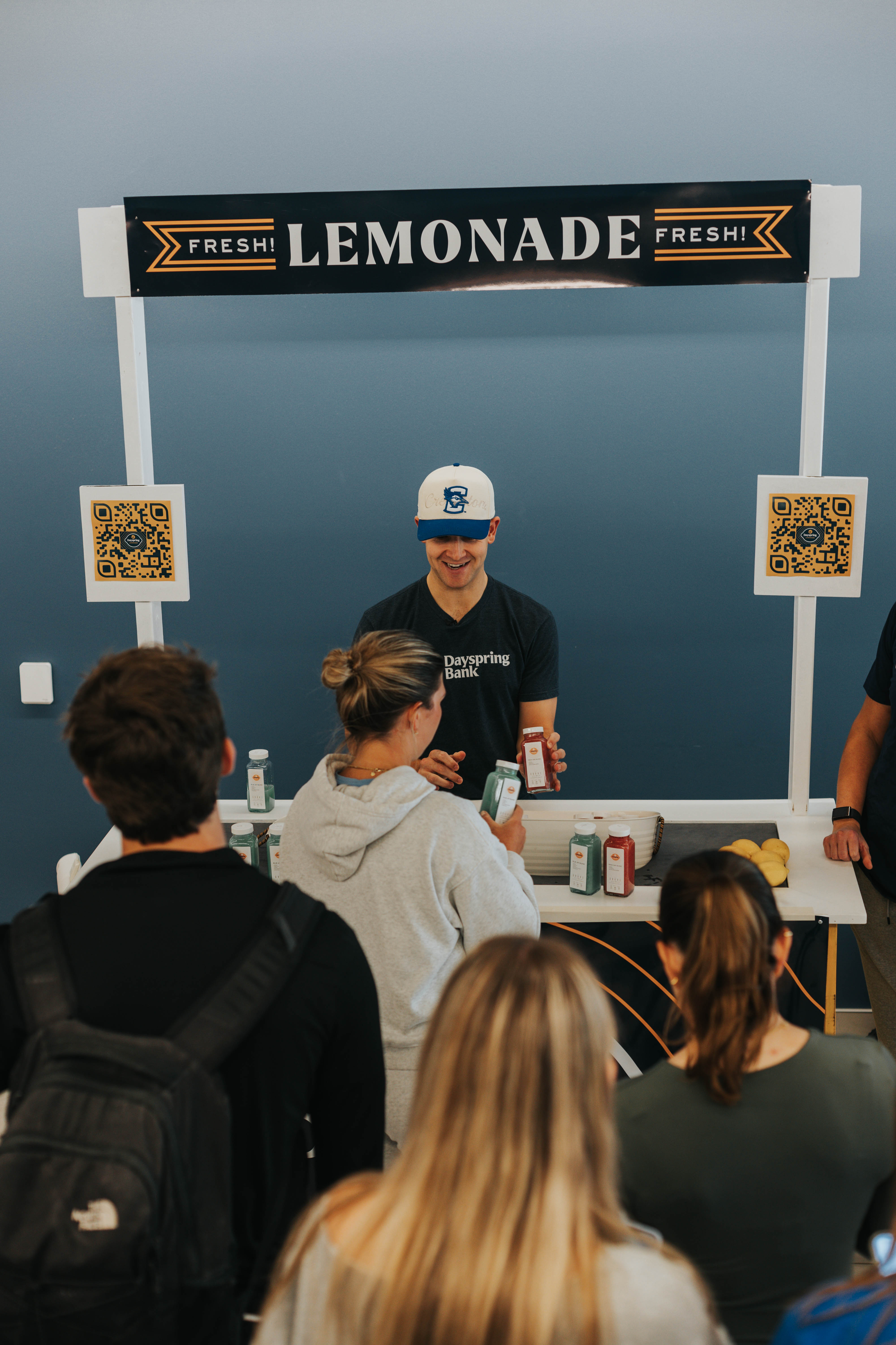 Steven promoting the bank, engaging students, and handing out free lemonade from the stand